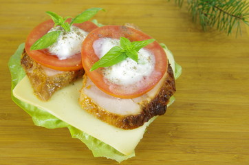 appetizing sandwich with meat and tomato on board