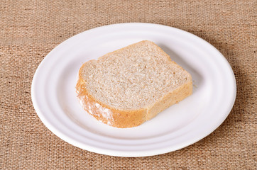 Sliced bread on sackcloth background