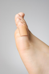 Closeup of a plaster on female toe