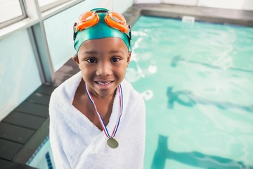 Cute little boy wrapped in towel with medal poolside - Powered by Adobe
