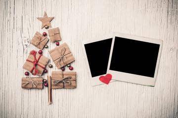 Christmas tree and instant photo on vintage wooden background