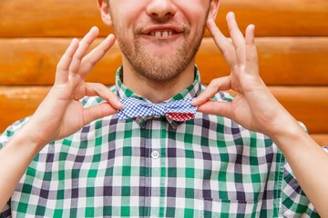 Fashion nerd correcting his bowtie