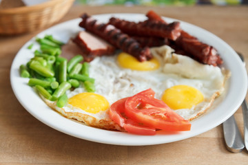breakfast with fried eggs, sausages