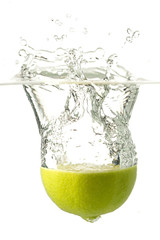Nice lime falling into water. White background.