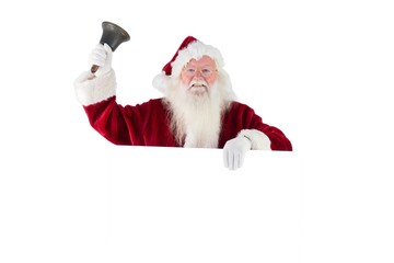 Santa holds a sign and rings his bell