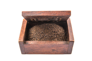Dried, processed and blended tea leaves in wooden box