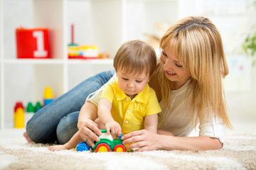 child boy and woman playing with toy indoor