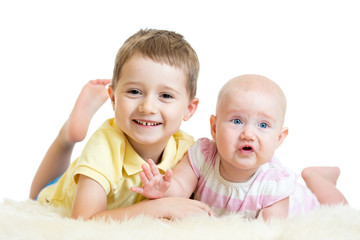 Cute kids brother and sister lying on floor