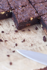 detail of square of brownies cut with knife on baking paper
