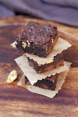 tower of delicious crusty brownies on wood background