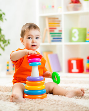 cute kid playing with color toy indoor