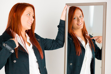 model isolated on plain background pointing to herself