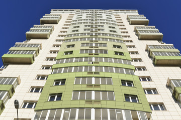 Fototapeta na wymiar High residential buildings on the background of blue sky