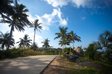 Fototapeta na wymiar Motorcycle at road on top mountains of Koh Samui