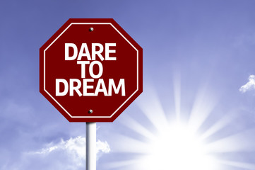Dare to Dream written on red road sign