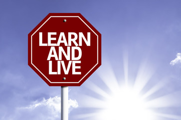 Learn And Live written on red road sign