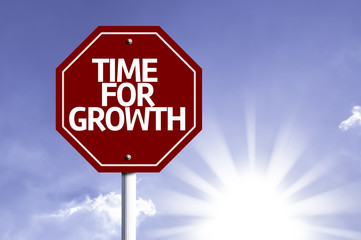 Time For Growth written on red road sign