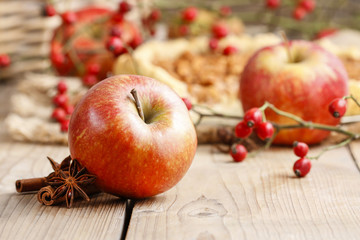 Red apple, cinnamon sticks and anise on wooden table