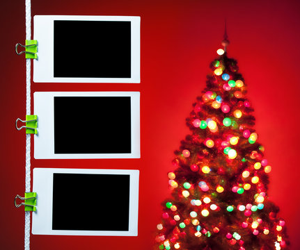 blank photos on red background with christmas tree