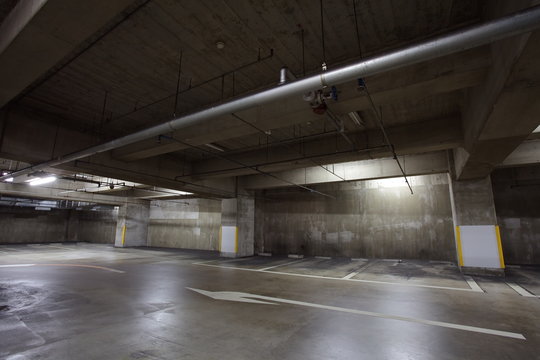 Empty underground car parking space at modern building