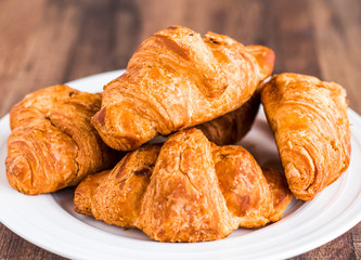 croissants with chocolate on a white plate, breakfast