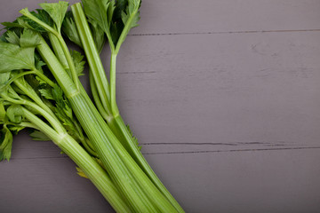 Green celery on the wood background