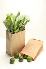 vegetables in paper grocery bag isolated over white