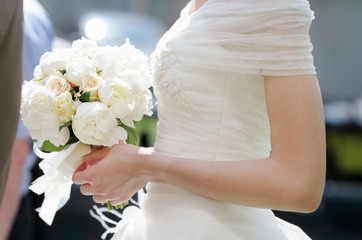 Obraz na płótnie Canvas Bride holding wedding flowers bouquet