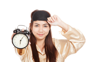 Happy Asian girl with eye mask  show alarm clock
