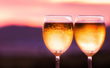 Glasses of beer on natural background