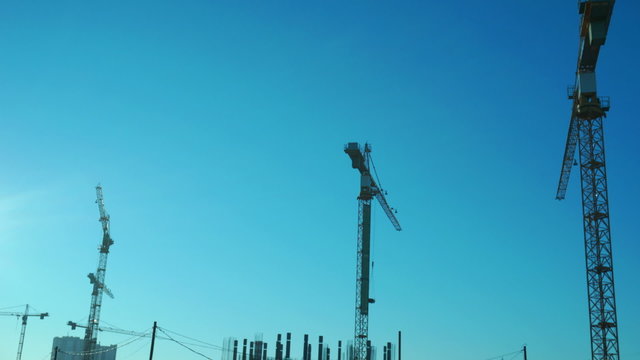 Crane working in construction site. Time lapse.