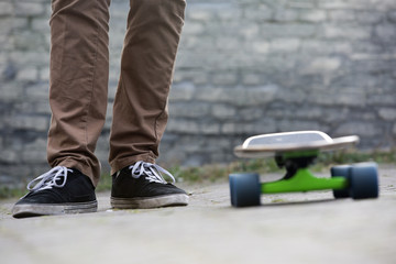 Skateboarder feet and skateboard in urban setting