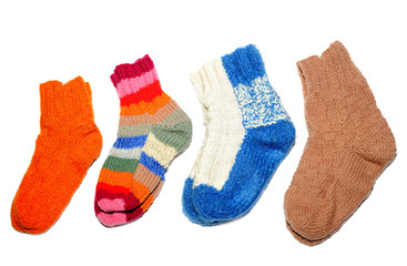 Warm knitted woolen socks knitting needles isolated on a white b