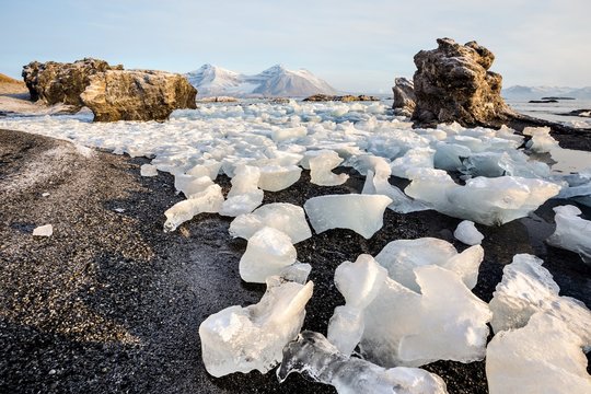 Rocks and glacier ice on the Arctic fjord shore