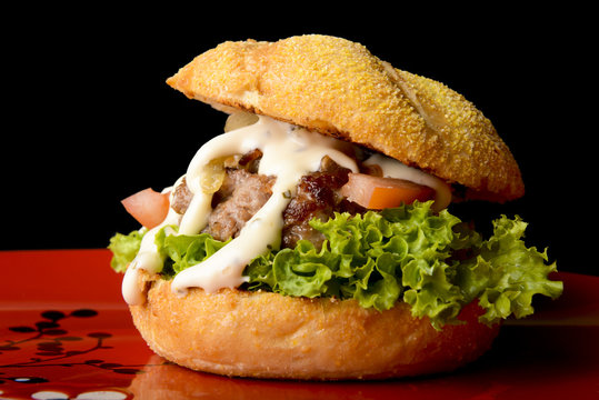 Tasty beef burger with onions and mayo