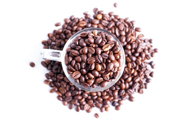 coffee beans in a glass dish on a top view of the isolated white