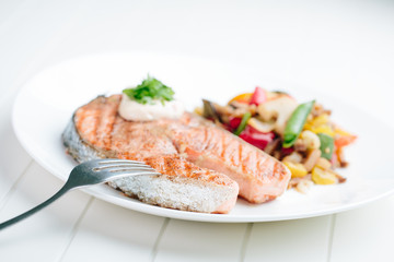 Grilled Salmon with Fresh vegetables on white background