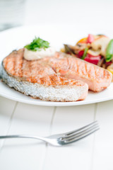 Grilled Salmon with Fresh vegetables on white background