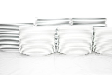 Many white different plates stacked together