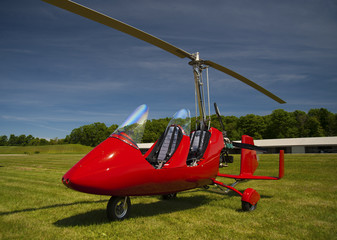 Red open-cockpit autogyro