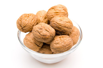 Nuts on glass bowl on white background