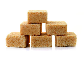 Cubes of cane sugar isolated on white background