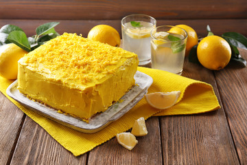 Tasty lemon cake on wooden table