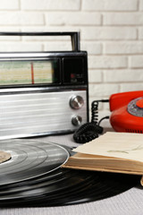 Obraz premium Retro composition with old phone, radio and books, close up
