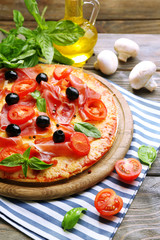 Delicious pizza served on wooden table