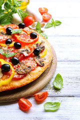 Delicious pizza served on wooden table