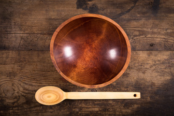 ladle and bowl on wooden background