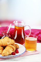 Breakfast with apple juice, jam and fresh croissants