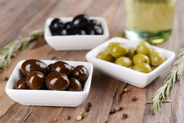 Different marinated olives on table close-up