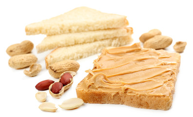 Creamy peanut butter and bread slices, isolated on white